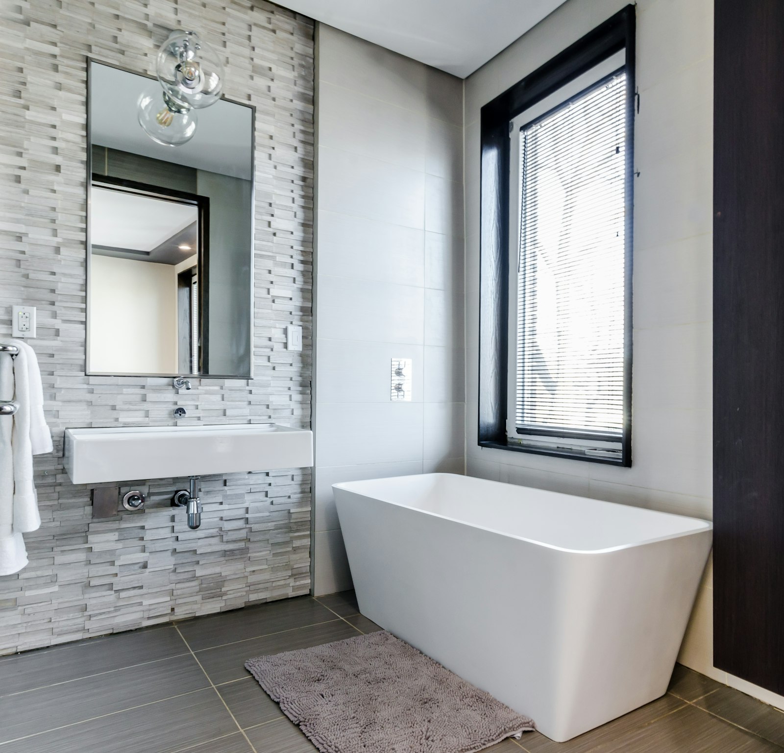Bathroom before — dated tile and worn fixtures