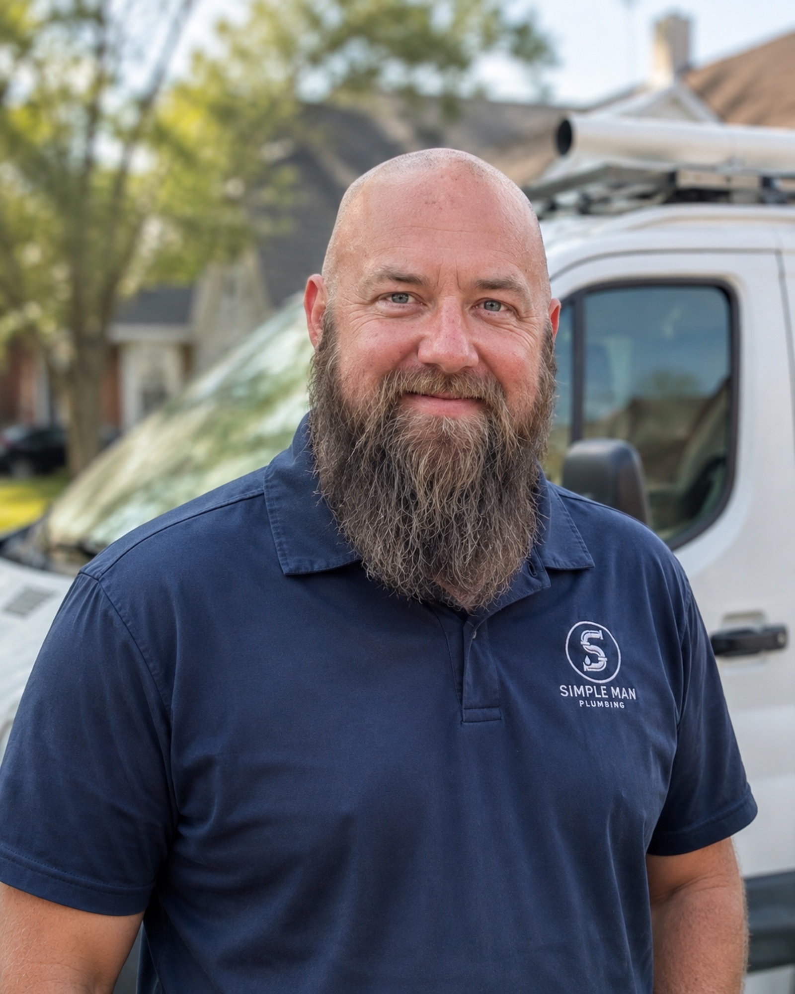 Dave, owner and lead plumber of Simple Man Plumbing, in front of his van
