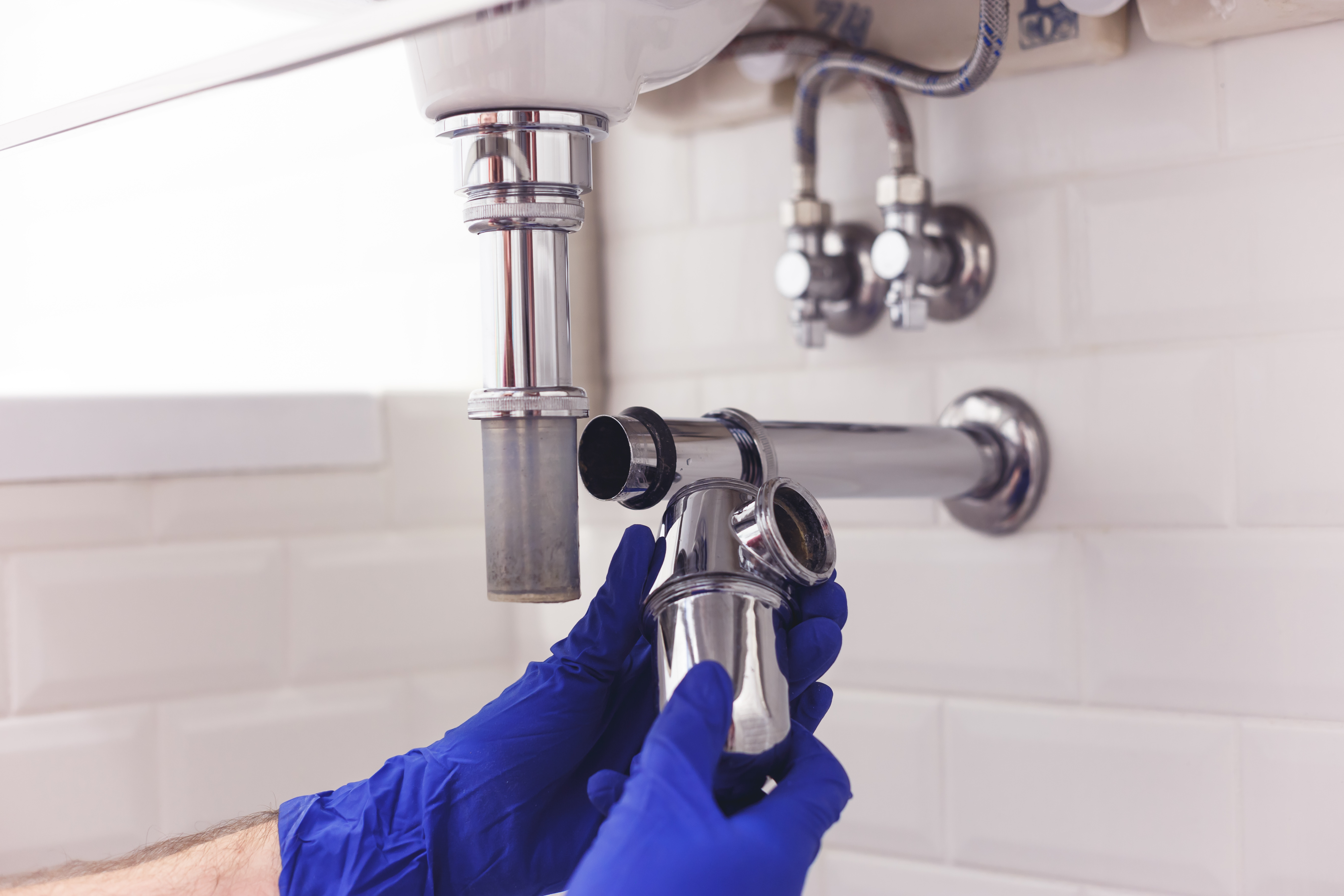 Plumber repairing a bathroom sink